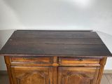 an old wooden cabinet with two doors and a drawer underneath it