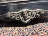 a close up of a decorative head on a bed