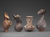 several different types of vases sitting on top of a gray surface