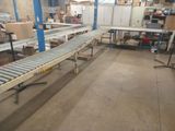 a conveyor belt in a warehouse with boxes on it
