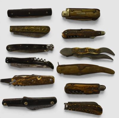 many different types of pocket knives on a white surface