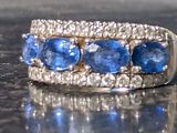 a close up of a blue and white ring on a table