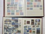 an open book with stamps on it sitting on top of a table