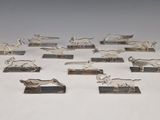 a group of silver figurines of animals on stands