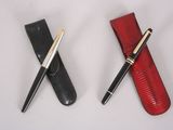 two pens sitting next to each other on a table