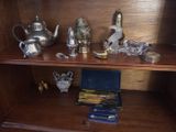 a wooden shelf with a teapot, tea pot, and other items on it