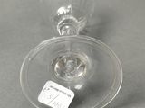 a wine glass with a label on it sitting on a table