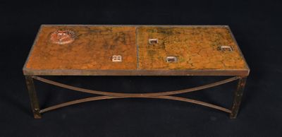 a small table with a metal base and a glass top