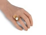 yellow gold plated ring with a white stone and a gold bead