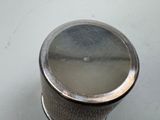 a silver cup that is sitting on a table