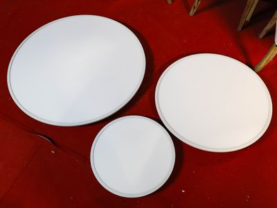 three white plates sitting on a red table