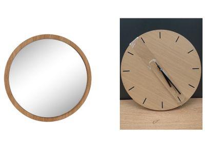 a clock and a mirror sitting on a table