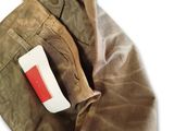 a pocket with a toothbrush in it and a toothpaste sticking out of it