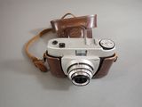 a small camera with a leather case on it