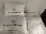 three pillows that are sitting on top of a bed