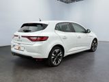 the rear end of a white car in a white room