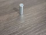an image of a metal screw on a wooden table