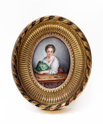 an old picture of a woman sitting at a table with a cabbage in her lap