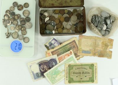 a box of coins and money sitting on a table