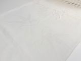 a close up of a white towel on a white table