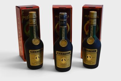 three bottles of liquor are sitting next to each other on a table