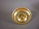a gold colored object on a gray surface