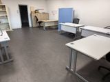 many desks and chairs in this empty office