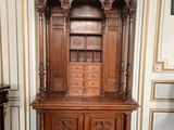 a large wooden cabinet in the middle of a room