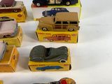 several toy cars are lined up in a row on a white surface