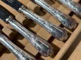 a lot of silverware in a box on the table