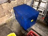 a blue box sitting on the ground next to a yellow box