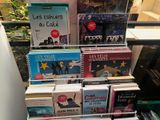 several books are stacked on top of each other on a table