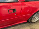 a red car that is parked in a lot