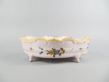 a close up of a white bowl with flowers on it