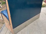 a blue chair sitting on top of a metal box