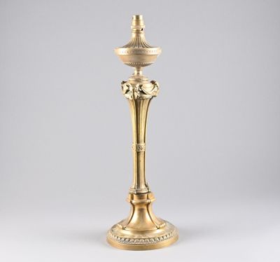 an antique brass candle holder with a bird on the top