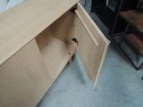 a wooden cabinet with a door open in a room