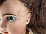 a small doll with a hair brush on it ' s head