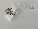 a ring with a flower on it sitting on a white surface