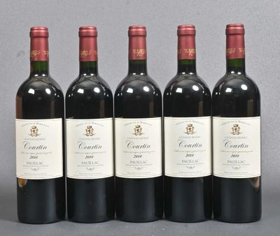 six bottles of wine are lined up in a row on a table