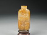 yellow jade snuffling bottle with carved dragon on stand
