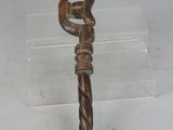 a small metal object on a clear plastic stand