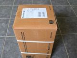 a box that is sitting on the floor next to a chair