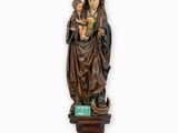 a statue of a woman holding a child on top of a table