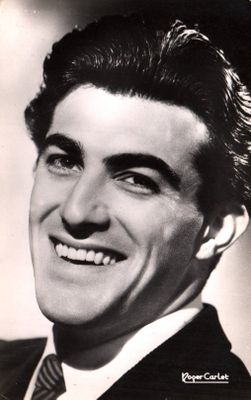 black and white photograph of a smiling man in a suit and tie