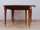 a small table with a drawer on it on a tile floor
