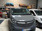two vans parked in a garage next to each other