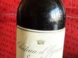 a bottle of wine sitting on a table next to a red box