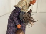 figurine of a woman with a basket of twigs on her head