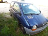 a small blue car that is parked in the grass